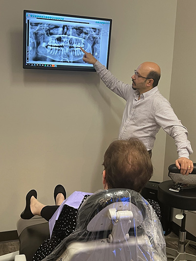 Dr. Mistry showing a patient a restorative dentistry scan